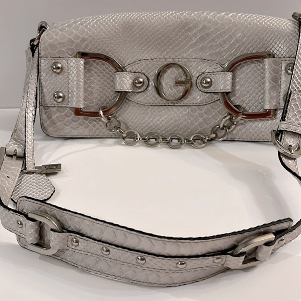 Guess Silver faux animal leather with Silver tone Hardware. Snap closure.